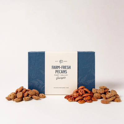 Box of 'Farm-Fresh Pecans' with pecans on a white background